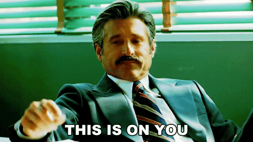 a man in a suit and tie is pointing with the words this is on you behind him
