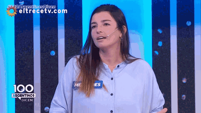 a woman wearing a name tag that says me es