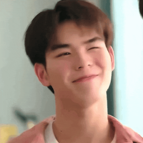 a close up of a young man making a funny face .