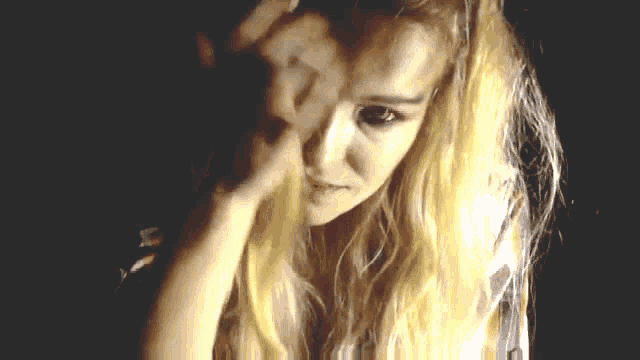 a close up of a woman 's face in a dark room