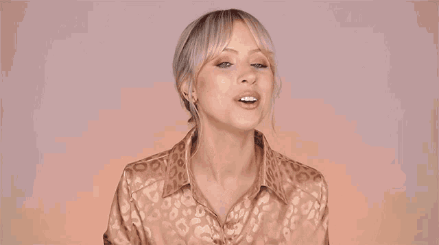 a woman in a leopard print shirt is clapping her hands in front of the words very good