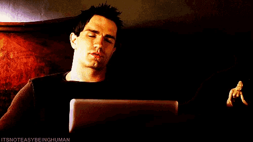 a man smoking a cigarette while looking at a tablet with the words " itsnoteasybeinghuman " below him