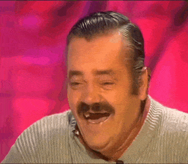 a man with a mustache is smiling with his mouth open