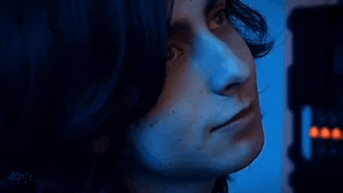 a close up of a man 's face with a blue background .