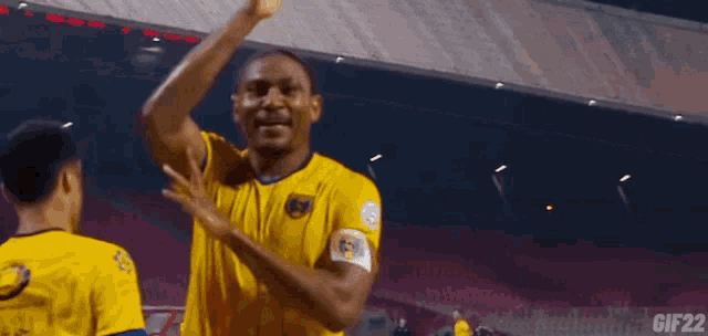 a soccer player wearing a yellow jersey with the number 3 on it