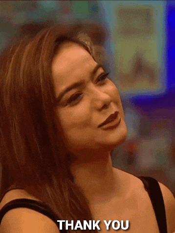 a woman is smiling and saying thank you in a gif