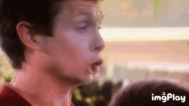 a close up of a man making a funny face with his mouth open
