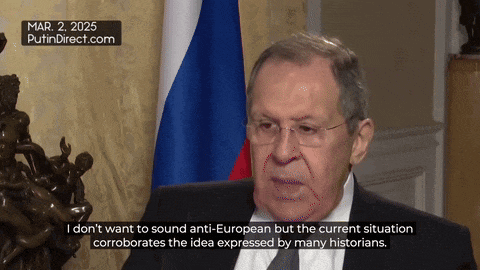 a man in a suit and tie is sitting in front of a flag and says mar 2 2025