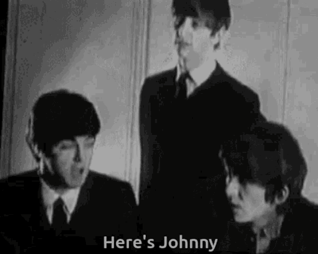 a black and white photo of the beatles with the words here 's johnny