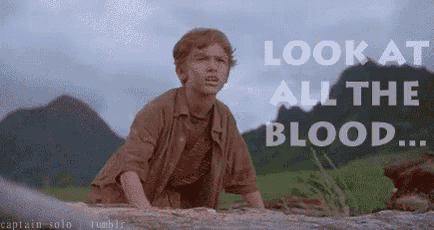 a boy is standing on a rock with the words look at all the blood