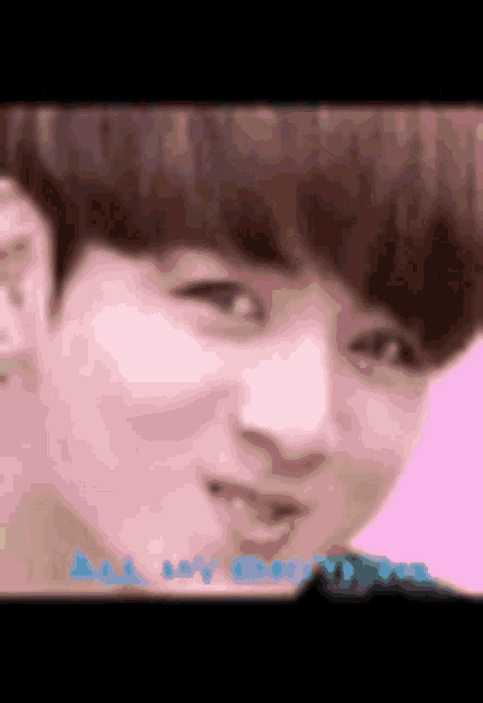 a close up of a person 's face with a pink background