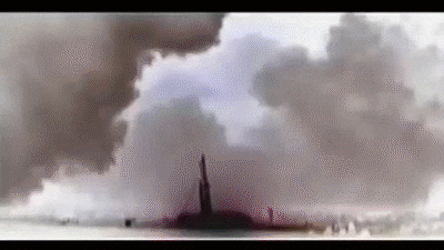 a statue of liberty is surrounded by smoke and a cloud of smoke .