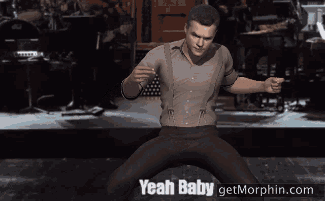 a man is dancing on a stage with the words yeah baby behind him