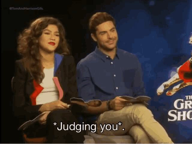 a man and a woman are sitting next to each other with the man saying judging you