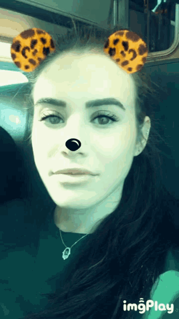a woman wearing leopard print ears and a nose is displayed on a screen that says imgplay