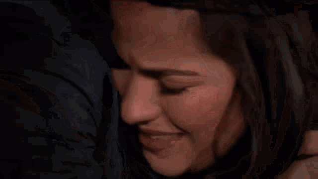 a close up of a man 's face with a tear running down his face .