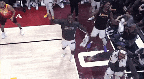 a basketball player wearing a lakers jersey is dancing on the court