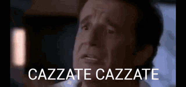 a close up of a man 's face with the words cazzate cazzate written above him