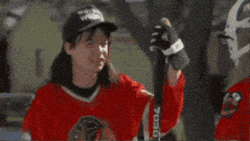 a hockey goalie wearing a voiture jersey stands behind the net