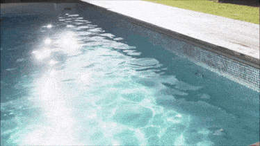 the sun shines through the water in a pool