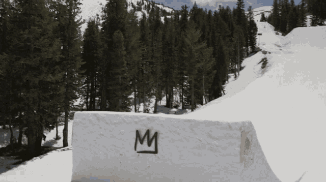 the letter m is painted on a snowy block