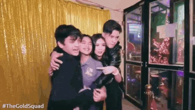 a group of young people are posing for a picture together in a photo booth .