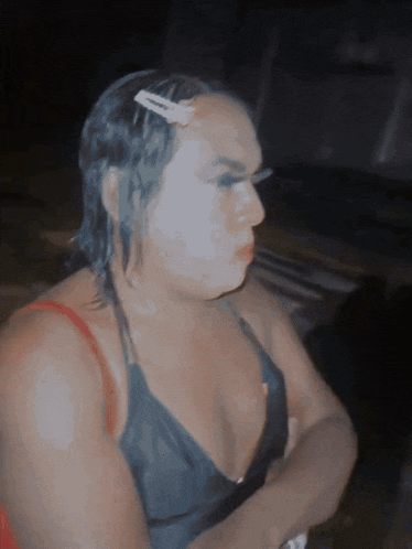 a woman with a clip in her hair is wearing a black top