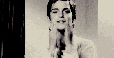 a woman is making a funny face with her hands .