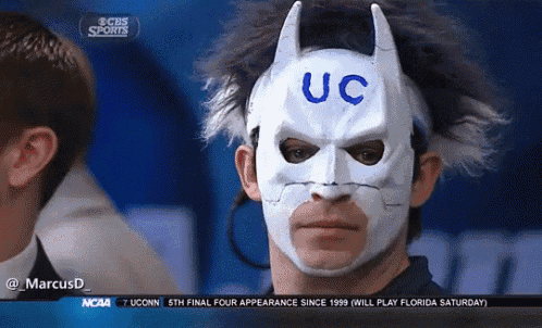 a man wearing a batman mask that says uc on it