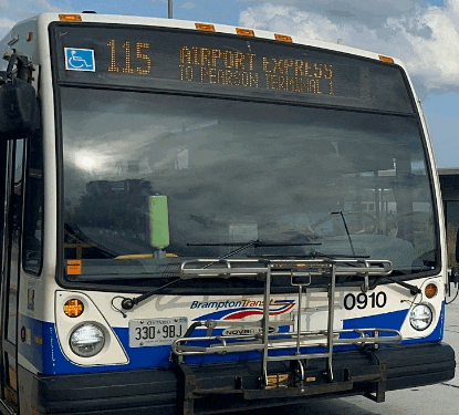 a blue and white bus with the number 115 on it