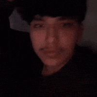 a close up of a man 's face with a hand on his head .