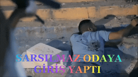 a man is laying on the ground with the words sarsilmaz odaya giris yapti