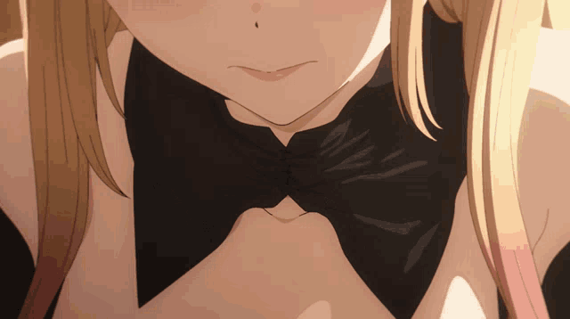 a close up of a woman 's neck with a black bow