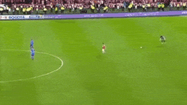 a soccer game is being played on a field with a sika ad in the background