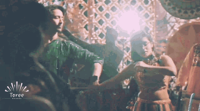 a man and a woman are dancing in front of a sign that says ioree
