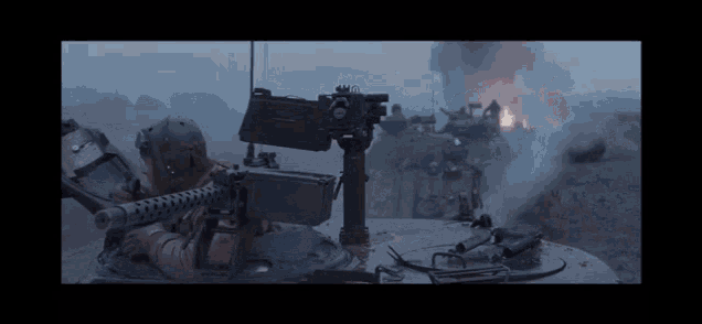 a group of soldiers are sitting in a tank holding guns .
