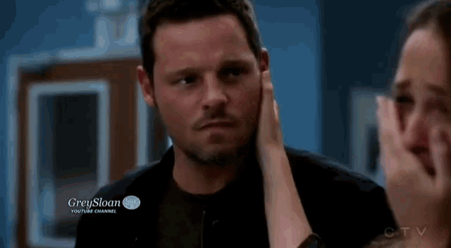 a man and a woman are looking at each other with a grey sloan youtube channel advertisement in the background
