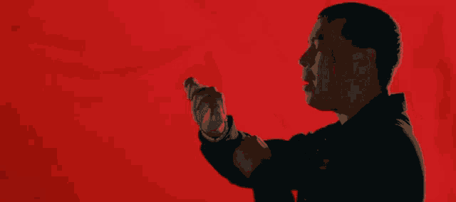 a man with blood on his face is making a fist