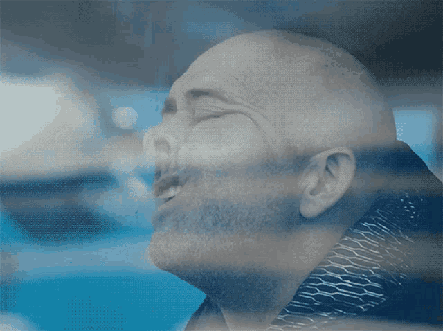 a close up of a man 's face with his eyes closed and his mouth open