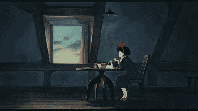 a girl with a red bow on her head sits at a table with a black cat