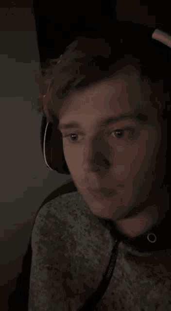 a man wearing headphones and a sweatshirt with the word reebok on it