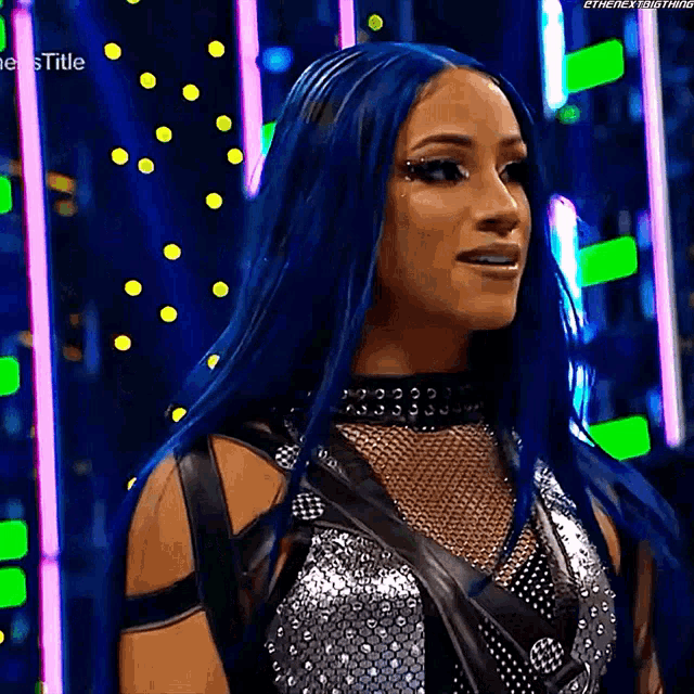 a woman with blue hair is wearing a silver and black outfit and a choker .