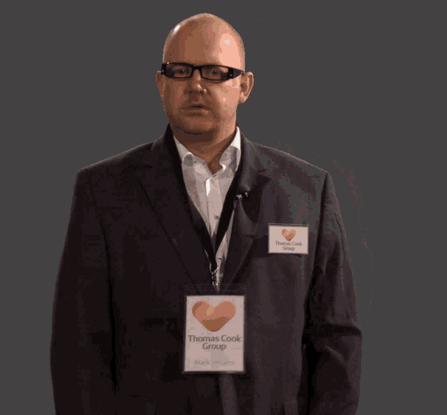 a man in a suit has a lanyard around his neck that says strekenwijf
