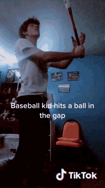 a baseball kid hits a ball in the gap on a tiktok video