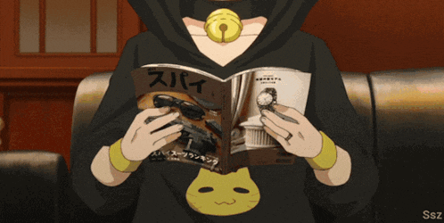a person reading a magazine with chinese writing