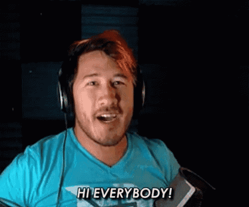a man wearing headphones is screaming into a microphone and saying `` hi everybody ! ''