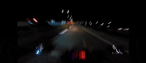 a blurry picture of a car driving down a highway