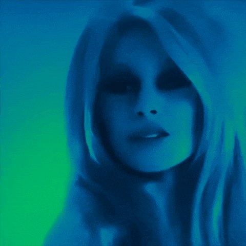 a close up of a woman 's face with blue hair