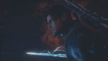 a man and a woman are fighting with glowing swords in a dark room