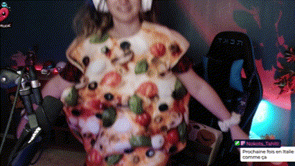 a woman in a pizza costume is standing in front of a microphone ..